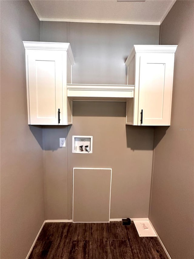 laundry area with crown molding, cabinets, dark wood-type flooring, and hookup for a washing machine