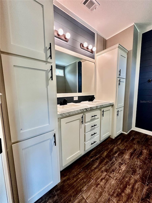 bathroom with vanity and wood-type flooring