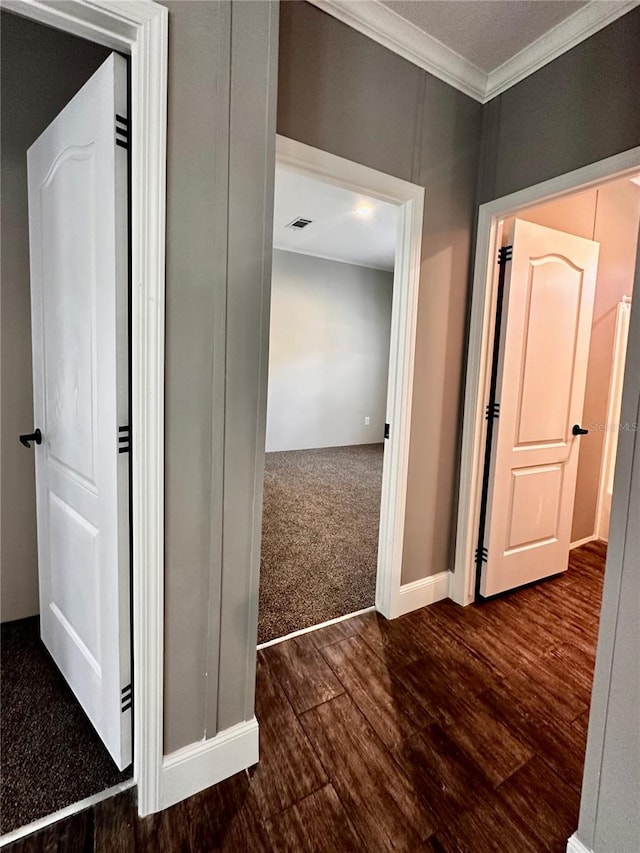 corridor featuring dark hardwood / wood-style flooring and crown molding