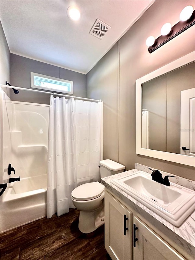 full bathroom with toilet, hardwood / wood-style floors, vanity, and shower / tub combo with curtain