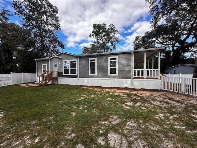 rear view of house with a yard