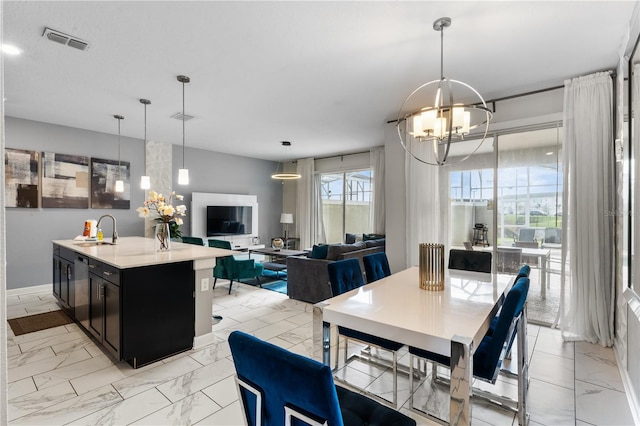 dining room with a notable chandelier, sink, and wine cooler