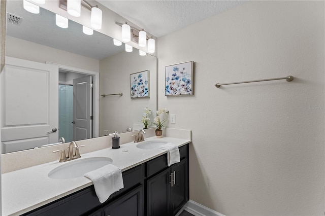 bathroom with vanity and a textured ceiling