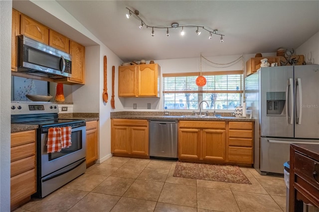 kitchen featuring sink, light tile patterned floors, and stainless steel appliances