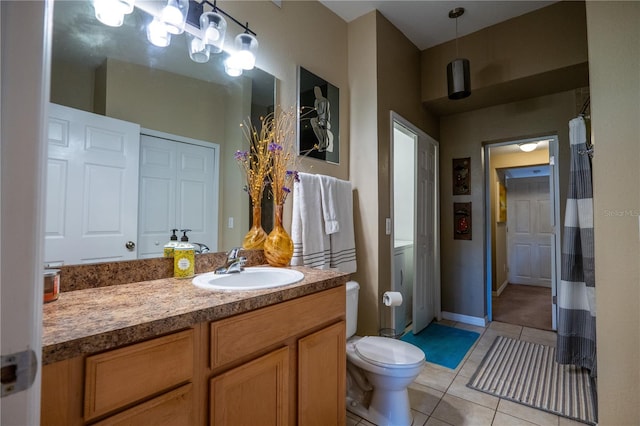 bathroom with tile patterned flooring, vanity, and toilet