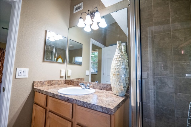 bathroom with vanity and a shower with shower door