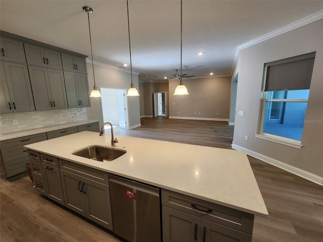 kitchen featuring dishwasher, a kitchen island with sink, sink, tasteful backsplash, and dark hardwood / wood-style flooring