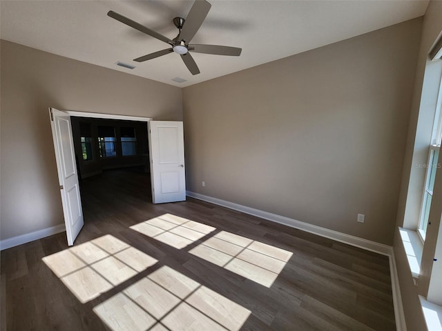 unfurnished bedroom featuring dark hardwood / wood-style flooring and ceiling fan