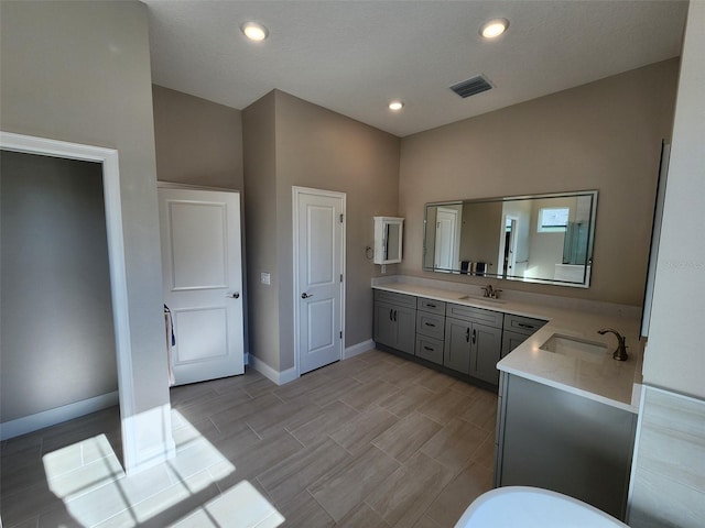 bathroom with vanity and a high ceiling