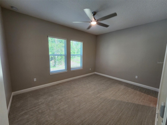 spare room with carpet, ceiling fan, and a textured ceiling