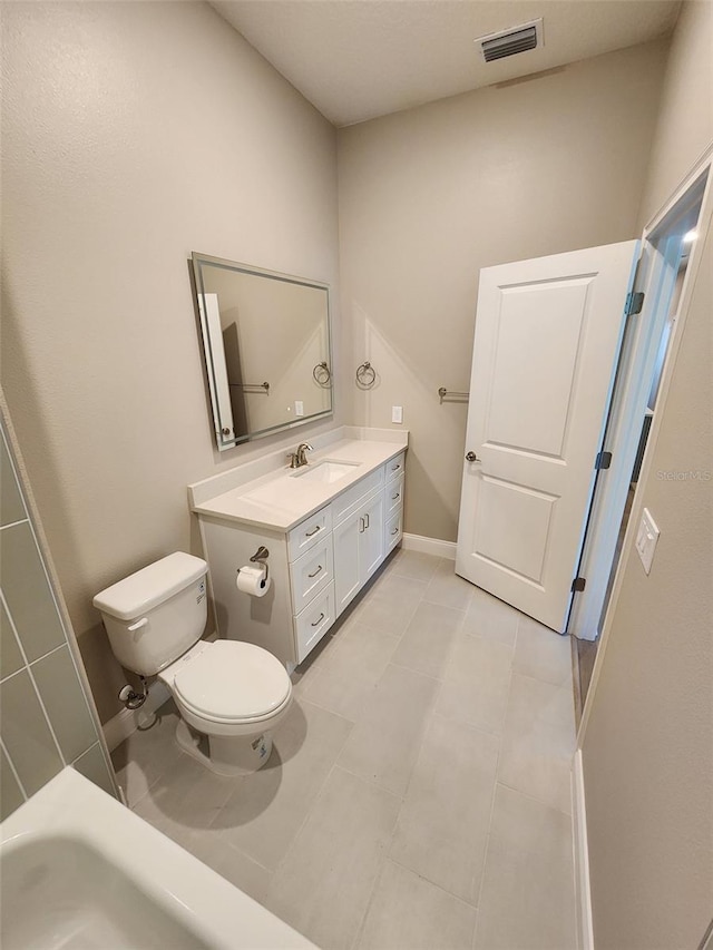 bathroom with tile patterned floors, vanity, and toilet