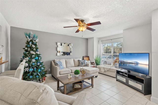 tiled living room with ceiling fan and a textured ceiling