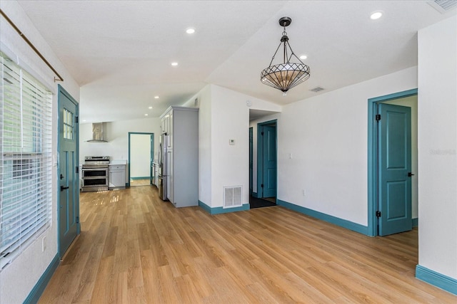 spare room featuring light hardwood / wood-style flooring and a textured ceiling