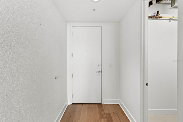 doorway with hardwood / wood-style flooring