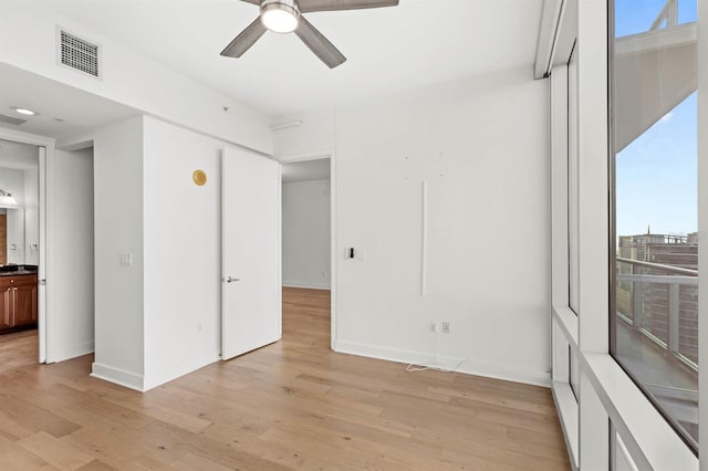 empty room featuring ceiling fan and light hardwood / wood-style floors