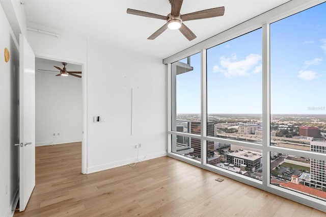 unfurnished room with ceiling fan and light hardwood / wood-style flooring