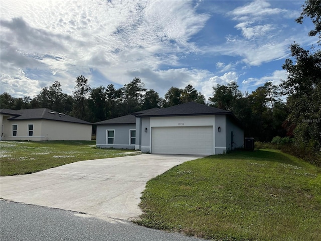 ranch-style house with a garage, central air condition unit, and a front lawn