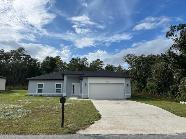 view of front of property featuring a front lawn and a garage