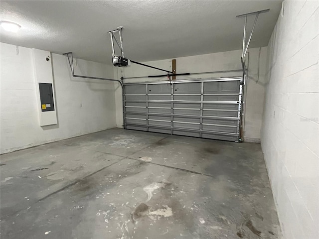 garage featuring electric panel and a garage door opener