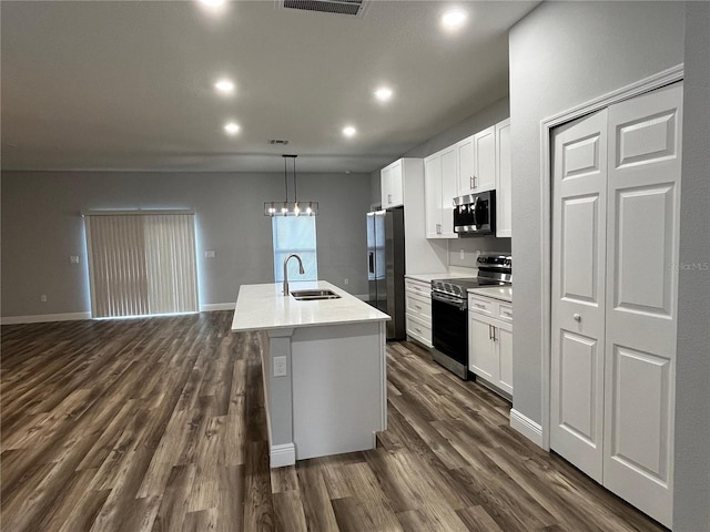 kitchen featuring sink, an island with sink, dark wood-type flooring, and appliances with stainless steel finishes