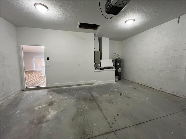 garage featuring water heater and a garage door opener