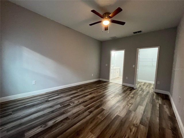 empty room with dark hardwood / wood-style flooring and ceiling fan