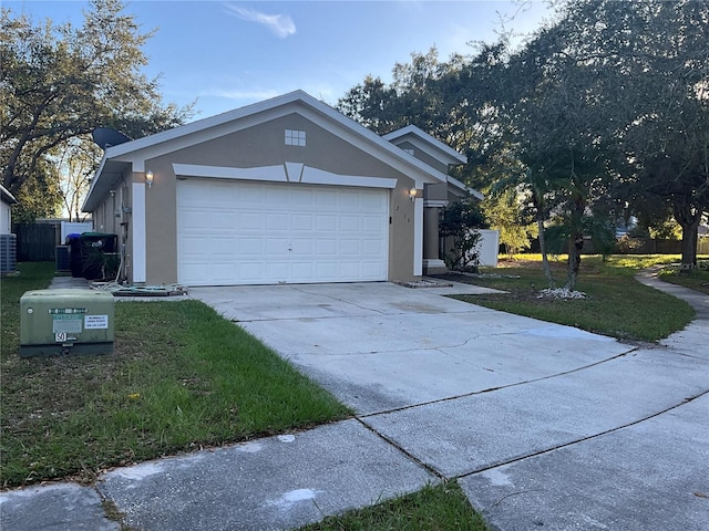 view of front of home with a front yard and a garage