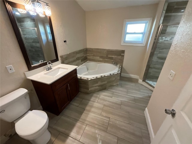 full bathroom featuring toilet, vanity, and shower with separate bathtub