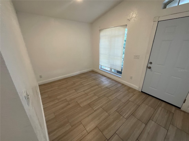 foyer entrance featuring vaulted ceiling