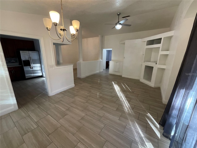 unfurnished dining area with ceiling fan with notable chandelier