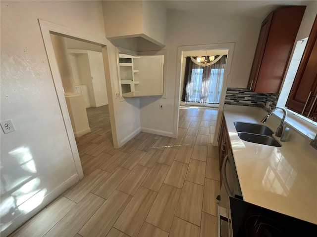 kitchen with sink, hanging light fixtures, an inviting chandelier, vaulted ceiling, and decorative backsplash