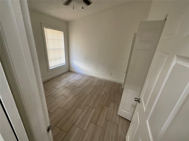 unfurnished room with ceiling fan and light hardwood / wood-style flooring