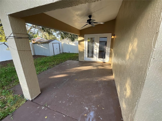 view of patio featuring french doors, a storage unit, and ceiling fan