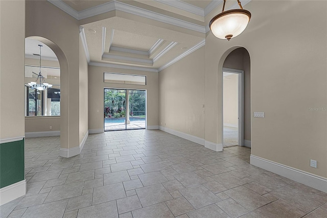 unfurnished room featuring a raised ceiling, crown molding, and a notable chandelier