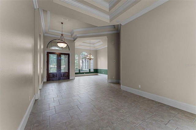 entrance foyer featuring a raised ceiling, french doors, a chandelier, and ornamental molding