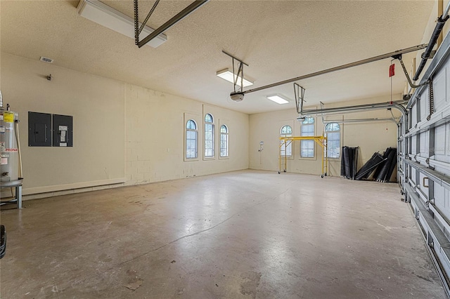 garage featuring electric panel, water heater, and a garage door opener