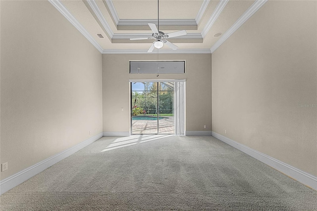 carpeted spare room featuring a tray ceiling, ceiling fan, and ornamental molding