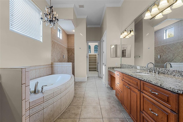 bathroom with tile patterned floors, crown molding, a chandelier, and a healthy amount of sunlight