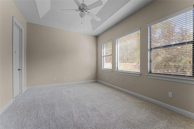 carpeted spare room with a textured ceiling and ceiling fan