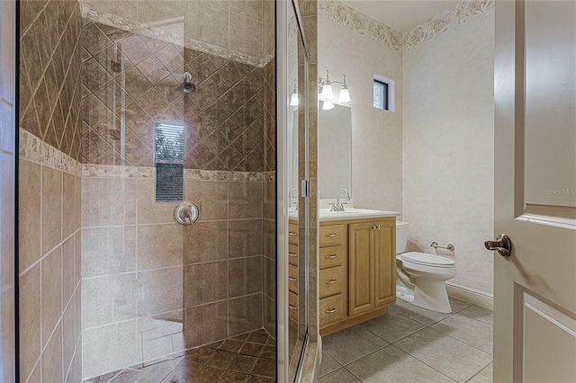 bathroom with tile patterned flooring, vanity, toilet, and an enclosed shower