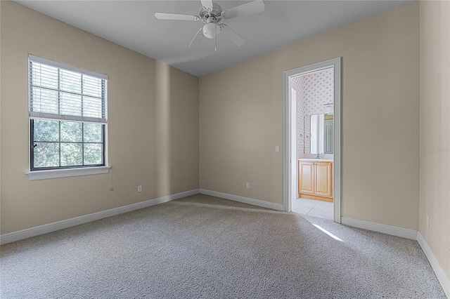 unfurnished room featuring ceiling fan and light colored carpet