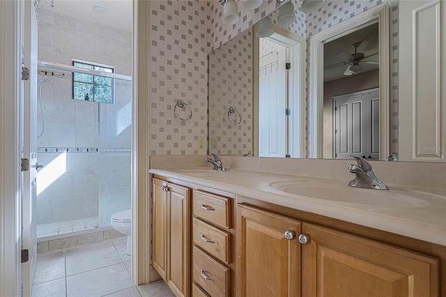 bathroom featuring ceiling fan, walk in shower, tile patterned flooring, toilet, and vanity