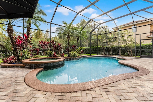 view of swimming pool with an in ground hot tub, a patio area, and a lanai