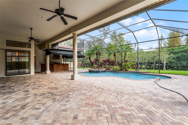 view of swimming pool with ceiling fan, a patio area, a bar, and glass enclosure