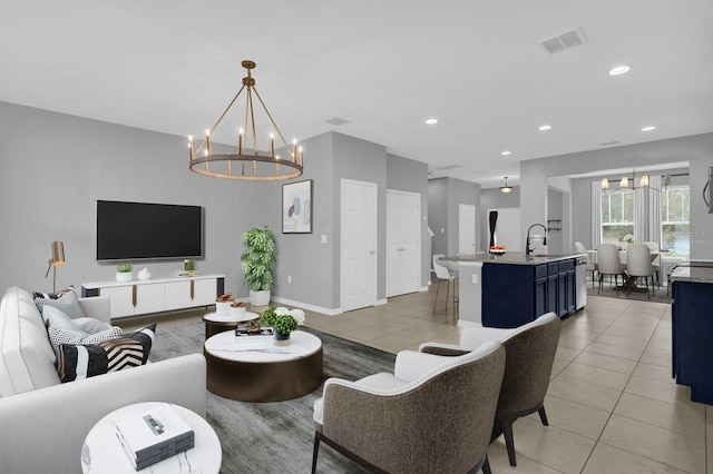 tiled living room with an inviting chandelier and sink