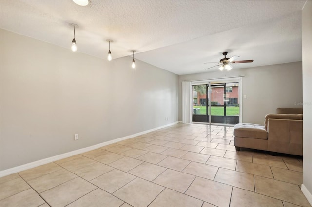 interior space with ceiling fan, light tile patterned flooring, and a textured ceiling