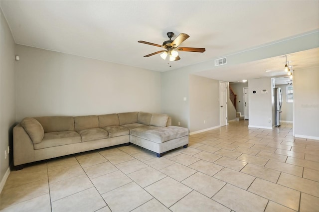 living room featuring ceiling fan and light tile patterned floors