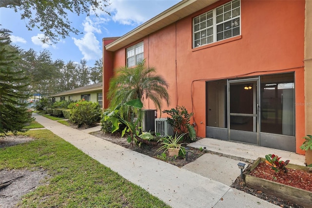 view of side of home with a yard