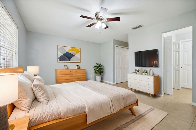 tiled bedroom featuring ceiling fan