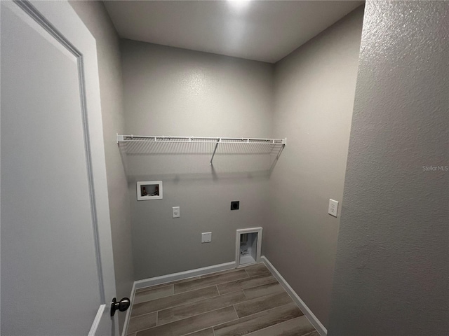 laundry area with washer hookup, wood finish floors, hookup for an electric dryer, laundry area, and baseboards